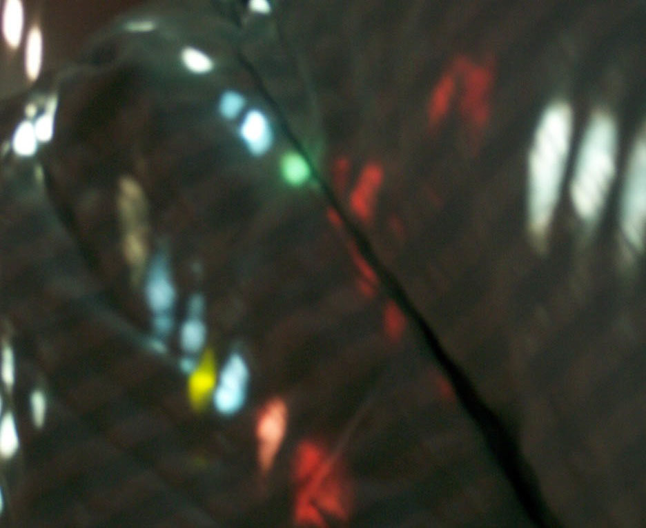 spots of sunlight (through roller shutter and stained glass) on the duvet; photo