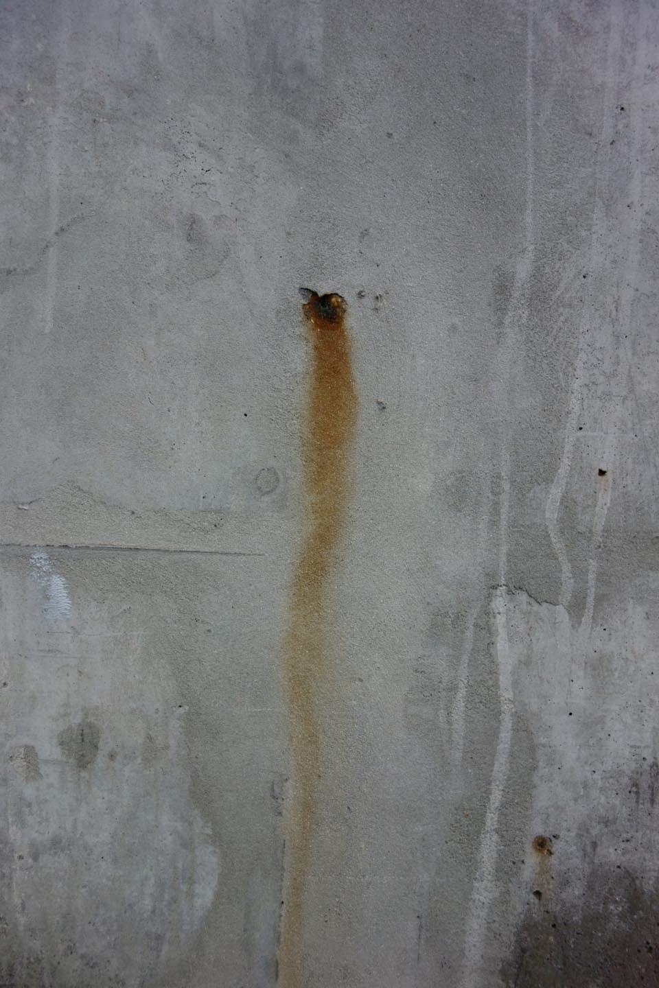 stained concrete with a rusting iron wound; photo