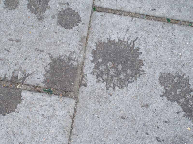 splashed bituminous drops on paving slabs; photo